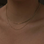 Close-up of Satellite Ball Chain Necklace layered with flat ball chain on chest