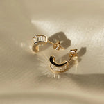 Sonia Studs gold-filled hoop earrings with baguette CZ stones displayed on satin fabric