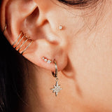 Close-up of IGGI Star Drop Earrings in 18k gold-filled with cubic zirconia charm styled on ear
