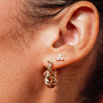 Model wearing Zara Twisted Hoops by IGGI Jewellery – 18k gold-filled twisted design hoop earrings.