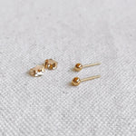 Everyday Ball Studs styled with additional earrings on model’s ear